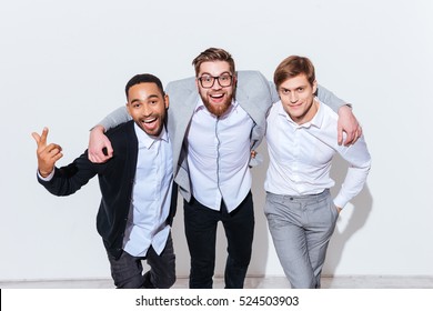 three-cheerful-young-men-standing-260nw-524503903.jpg